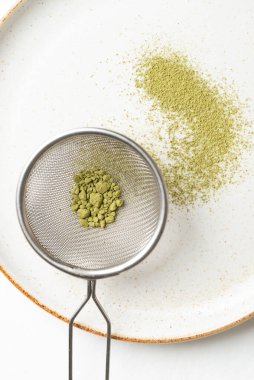 Tabakta kibrit yeşili çay tozu tabakta. Çayı karıştırmak için hazırlayın.