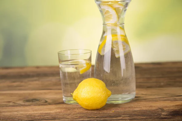 carafe with water, lemon