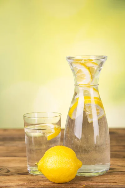 carafe with water, lemon