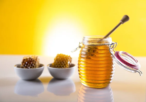 Honey in jar with honey dipper on wooden background — Stock Photo, Image