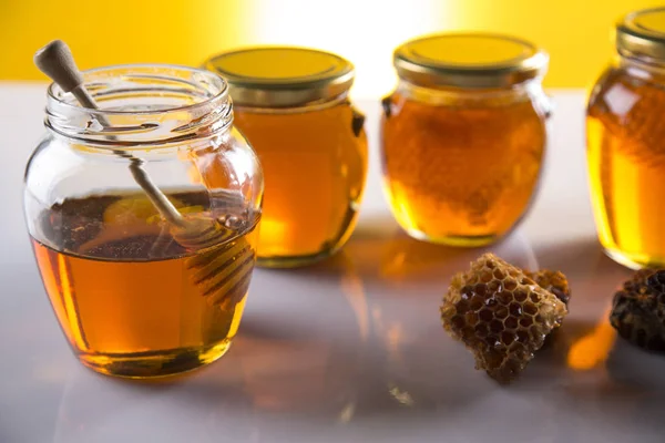 Miel en tarro con cazo de miel sobre fondo de madera —  Fotos de Stock