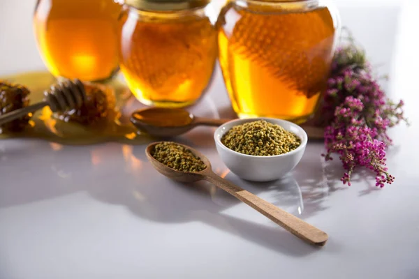 Honey in jar with honey dipper on wooden background — Stock Photo, Image