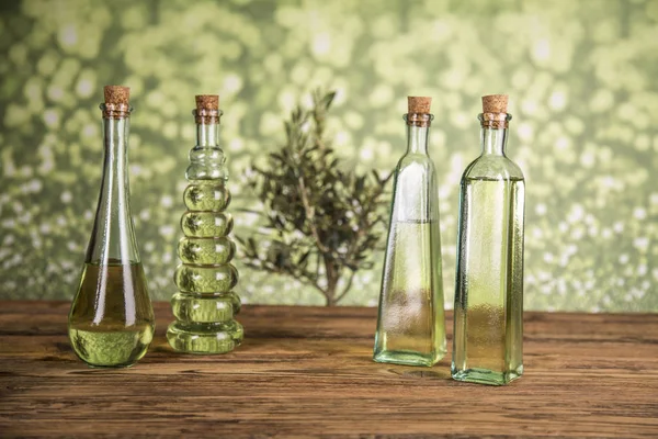 Olive tree and bottles with oil, olives on a wood table — Stock Photo, Image