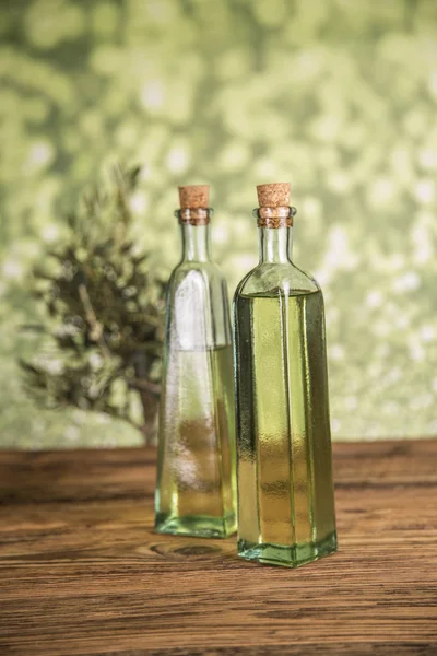 Olive tree and bottles with oil, olives on a wood table — Stock Photo, Image