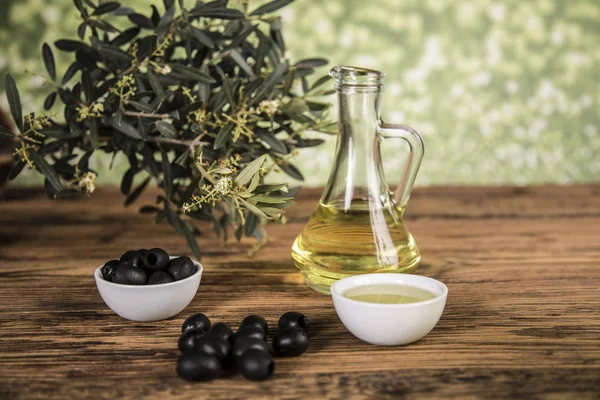 Olive oil and olive tree and black olives and bottles with olive