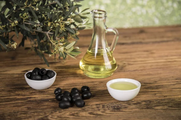 Olive oil and olive tree and black olives and bottles with olive