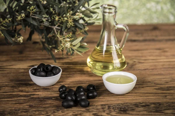 Olive oil and olive tree and black olives and bottles with olive