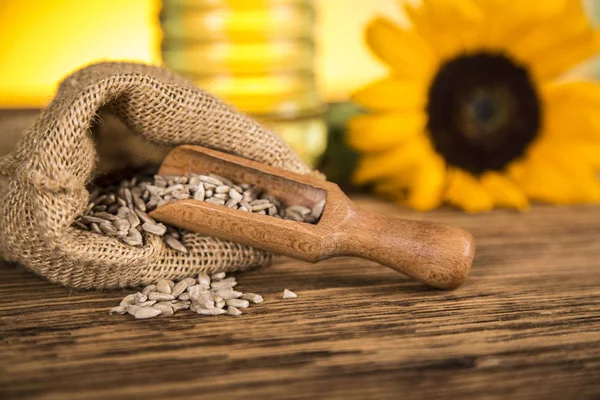 Sunflower oil in a bottle and sunflower flowers and sunflower se — Stock Photo, Image