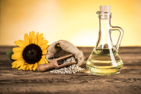 Sunflower oil in a bottle and sunflower flowers and sunflower se