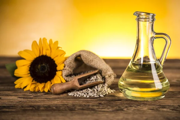 Sunflower oil in a bottle and sunflower flowers and sunflower se