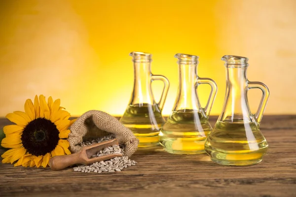 Sunflower oil in a bottle and sunflower flowers and sunflower se