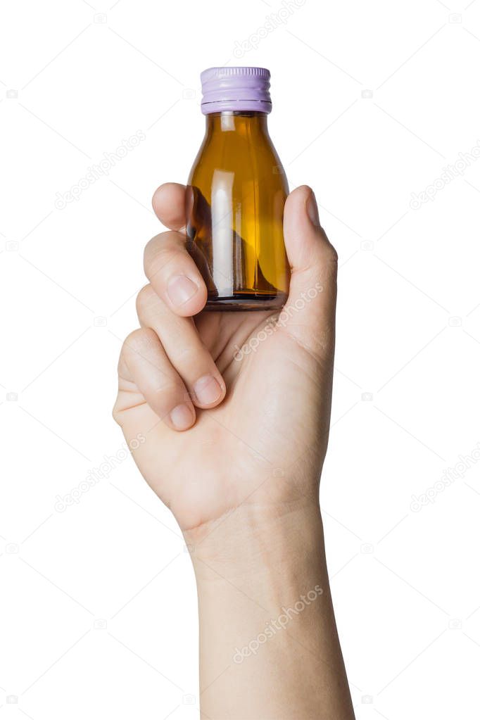 Woman's hand holding empty small brown medicine bottle liquids transparent on white background, File contains a clipping path.