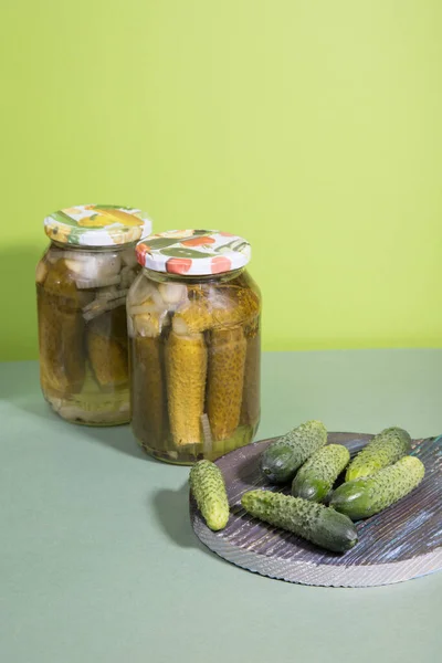 Pickled cucumbers cornichons. Pickled pickles on a wooden cutting Board