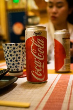Ho Chi Minh şehri, Vietnam - 22 Haziran 2020: Masada serin Cocacola kutuları, Ho Chi Minh, Vietnam 'da bir Japon suşi restoranında masa.