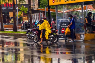Ho Chi Minh şehri, Vietnam - 08 Ağustos 2020: Yerel halk Emart süpermarketinden alışveriş yapıyor, tıbbi maskeler takıyor, yağmurda motosiklet sürüyor ve Covid-19 salgınında sosyal mesafeyi koruyorlar.