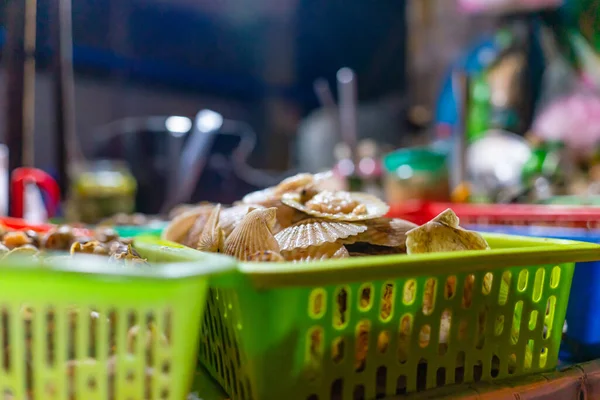 Seafood on the counter and Snail\'s for sale in a night market in Ho Chi Minh city (Saigon), Vietnam. Food and drink concept