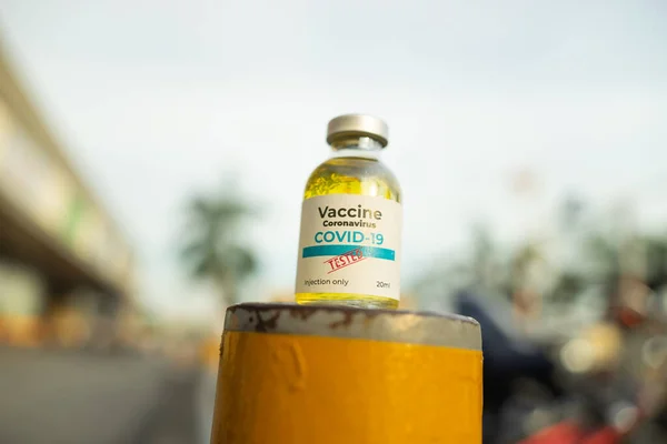 A single bottle vial of Covid-19 coronavirus vaccine in public. The coronavirus is expected to end. Hope, healthcare, medical concept.