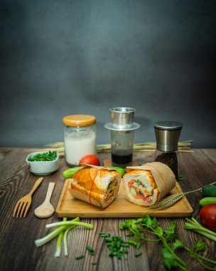 Yemek molasında. Ünlü Vietnam yemekleri Banh mi thit ve sade kahveydir, hammaddeyle doldurulmuş ekmeğin popüler sokak yemekleri: domuz eti, jambon, börek, yumurta ve taze ottur. Tipik Vietnam sandviçi.