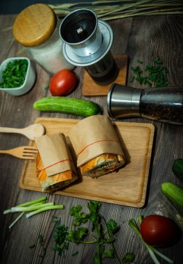 Yemek molasında. Ünlü Vietnam yemekleri Banh mi thit ve sade kahveydir, hammaddeyle doldurulmuş ekmeğin popüler sokak yemekleri: domuz eti, jambon, börek, yumurta ve taze ottur. Tipik Vietnam sandviçi.