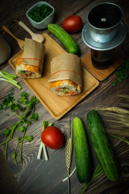 Yemek molasında. Ünlü Vietnam yemekleri Banh mi thit ve sade kahveydir, hammaddeyle doldurulmuş ekmeğin popüler sokak yemekleri: domuz eti, jambon, börek, yumurta ve taze ottur. Tipik Vietnam sandviçi.