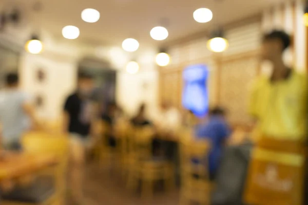 Blurred background of Vietnamese restaurant with people. Food and drink concept.