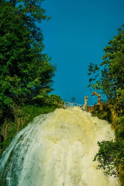 Dai Yem waterfall and red heart bridge. This is a nice waterfall in Moc Chau, Son La province, Vietnam. Travel and nature concept.