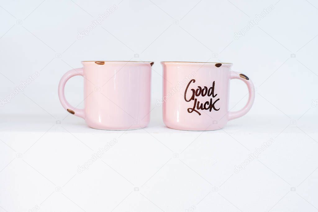 Two pink cups for hot drinks in antique iron in, frayed with the inscription 