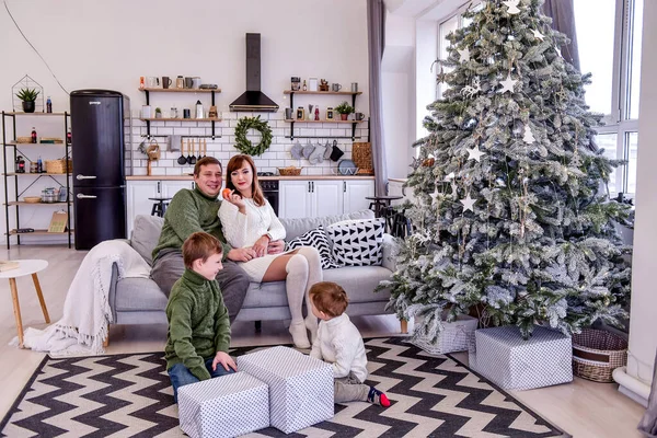 Una Familia Cuatro Está Sentada Junto Árbol Navidad Desempacando Regalos — Foto de Stock