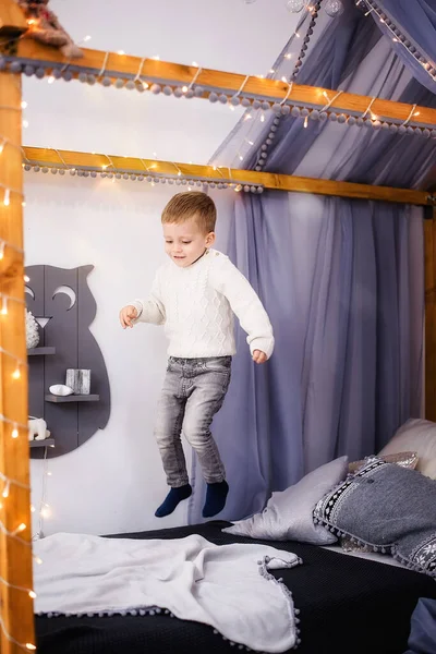 Niño Pequeño Suéter Punto Blanco Jeans Salta Alegremente Juega Cama —  Fotos de Stock