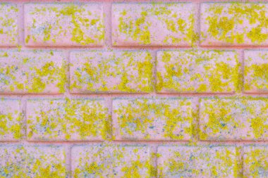 Eski tuğla çit pembeye boyanmış. Güzel yosunlarla kaplı pembe bir duvar.