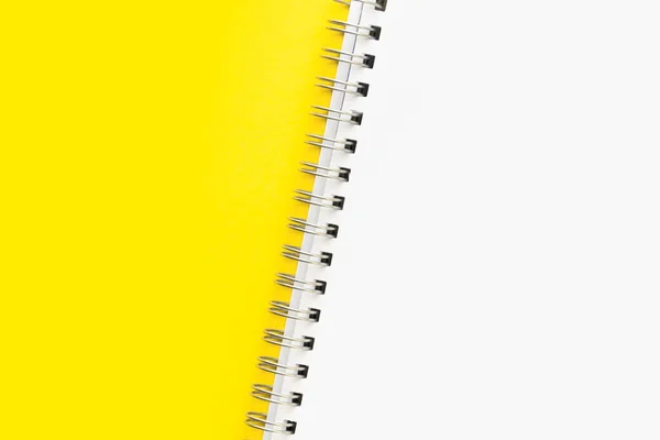 Layout or mockup. White sheet of an open notebook with a spiral on a yellow background. Copy space or space for text. — Stock Photo, Image