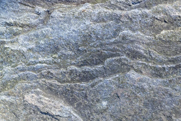 Surface rugueuse, inégale, irrégulière en pierre de granit. Relief texturé naturel fond gris. — Photo