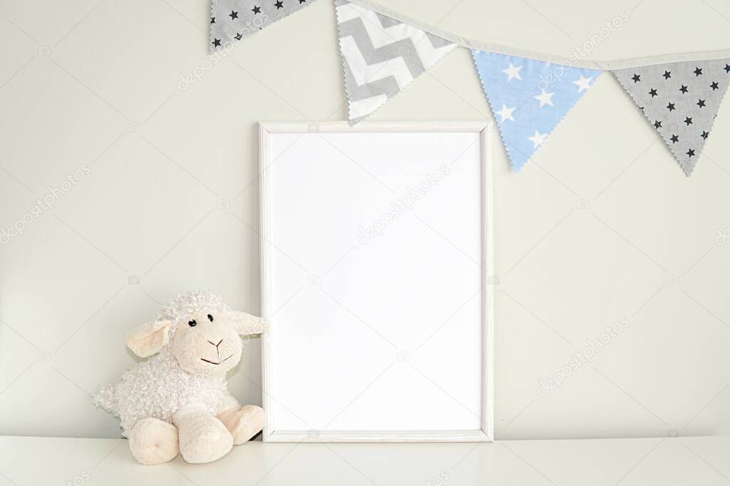 White frame mock up for photo, print art, text or lettering, with nursery toys. Blank frame on white table.