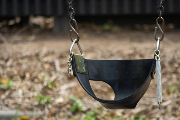 Empty toddler or baby swing at a playground. — Stock Photo, Image