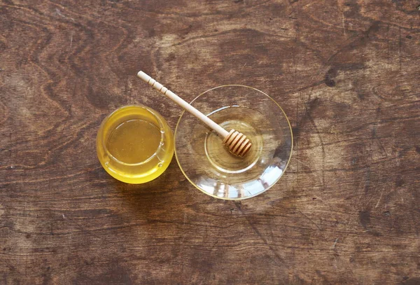 The idea of natural products.On a wooden natural ancient background honey and a spoon with honey.