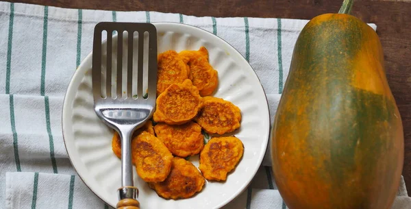 Pumpkin and millet pancakes. Russian national cuisine, healthy breakfasts. Popular in kindergartens, good for toddlers and older people. Authentic Russian still life. — Stock Image Pumpkin Millet Pancakes Russian National Cuisine Healthy Breakfasts Popular Kindergartens Royalty Free Stock Photos