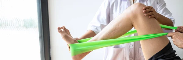 Female Physiotherapist Working Examining Treating Injured Leg Male Patient Doing — Stock Photo, Image
