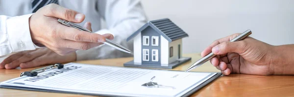 Estate agent are presenting home loan and giving house to client after discussing and signing agreement contract with approved application form, Home Insurance and Real estate investment concept.