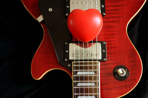 love guitar,red  heart on guitar, Used to play music and notes, For sing a song.
