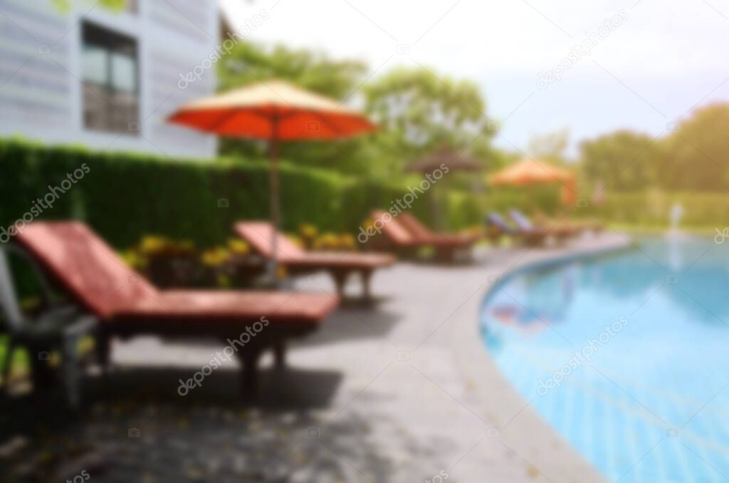 Swimming pool and canvas bed, blur photo