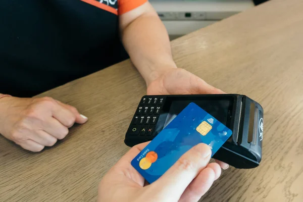 Woman at the time of credit card payment at the payment terminal