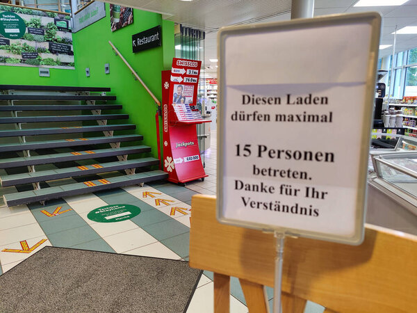Kappel, Solothurn - Switzerland - May 13, 2020: Signs and arrows made of adhesive tape on the floor in front of the Gunzgen South service area to the restaurant and grocery store. The new normal.