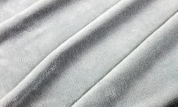 a background of soft synthetic fibers from which bathrobes are sewn