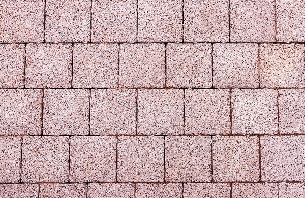 Pink pavement background made of cement and small pebbles