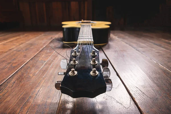 Ahşap zemin üzerinde akustik gitar enstrümanı