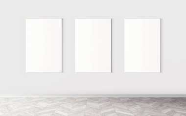 Duvarda üç tane boş tuval var. Tasarım önizlemeniz için bir model. Reklam malzemeleri için iyi bir kullanım.