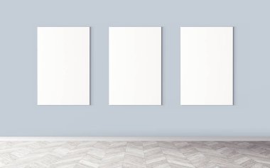 Duvarda üç tane boş tuval var. Tasarım önizlemeniz için bir model. Reklam malzemeleri için iyi bir kullanım.
