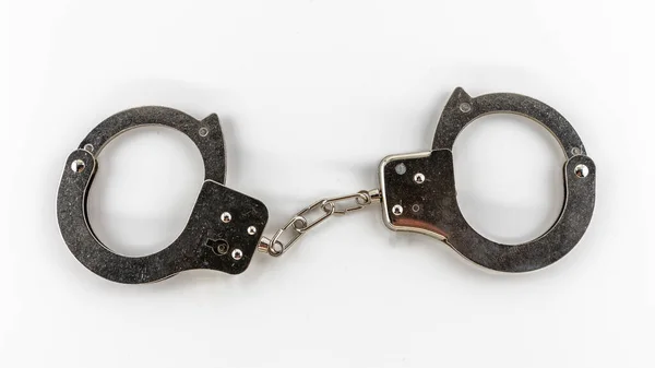 Metal handcuffs on a white background, isolates — Stock Photo, Image