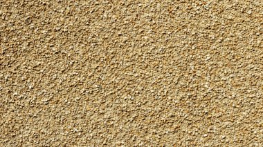 Küçük taşlardan, arka planlardan, dokulardan yapılmış sarı dokuma duvarı