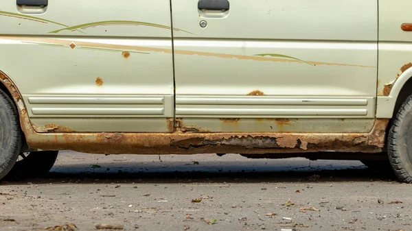 old and rotten thresholds of a yellow rarity car